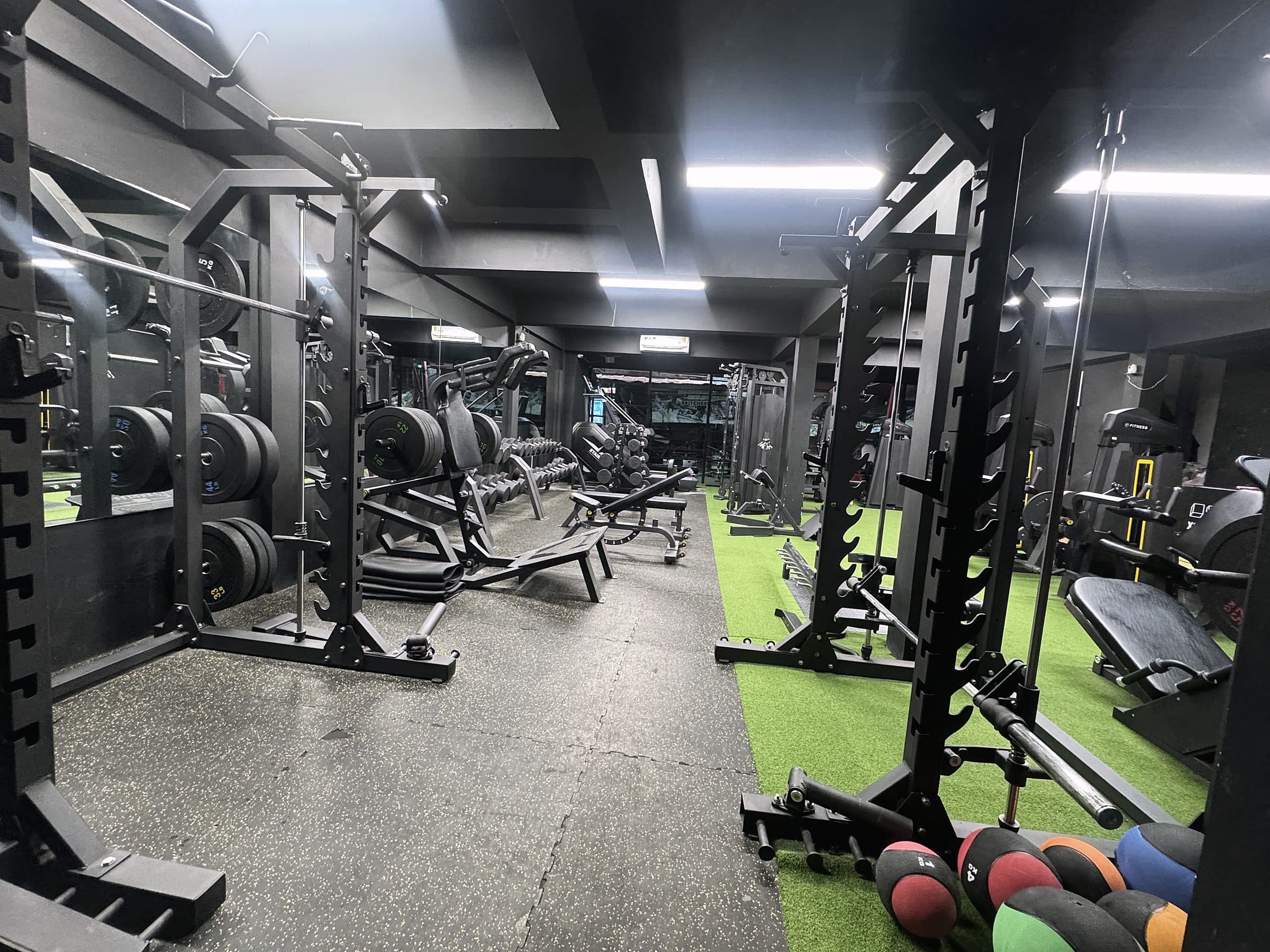 Squat rack and medicine balls on the turf