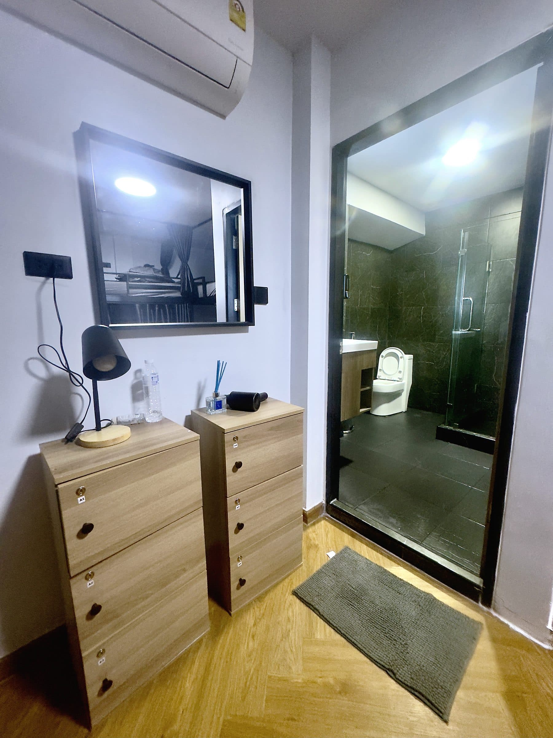 Room with chest of drawers, full-length mirror and its own bathroom